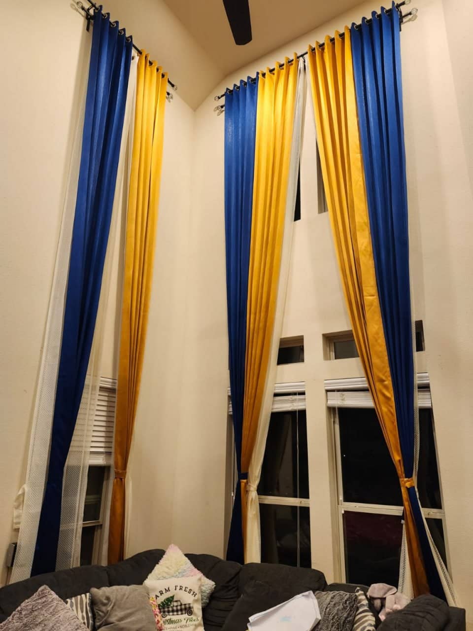 Floor-length curtains hung on decorative crystal finial curtain rods in a bedroom