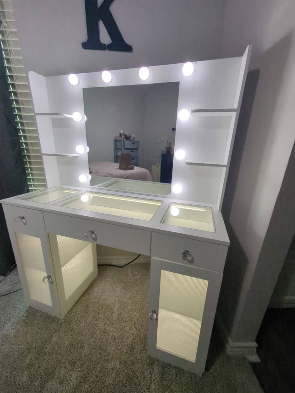 Decorative vanity mirror mounted on a bathroom wall above a countertop